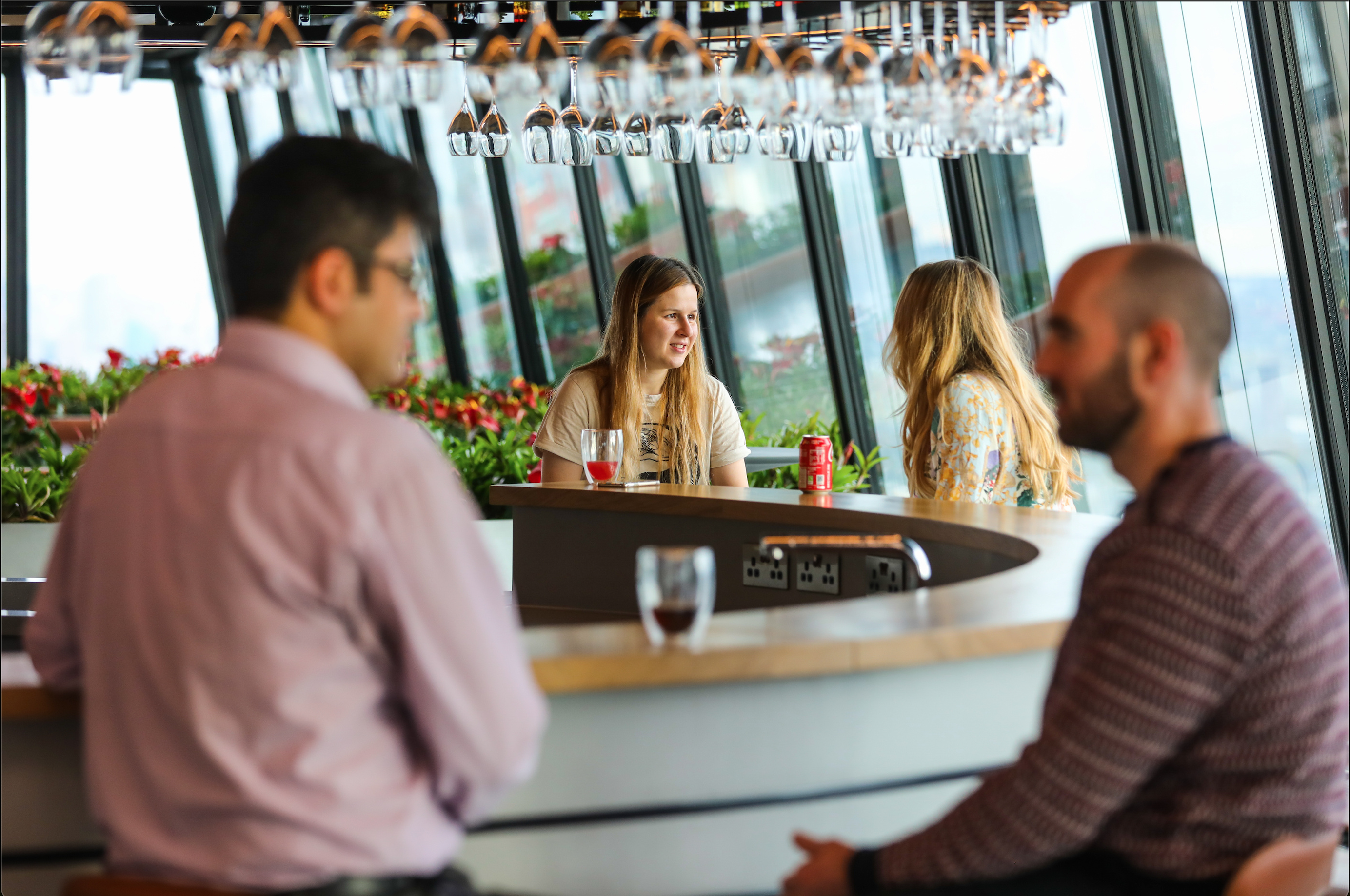 Employees socialising around table.
