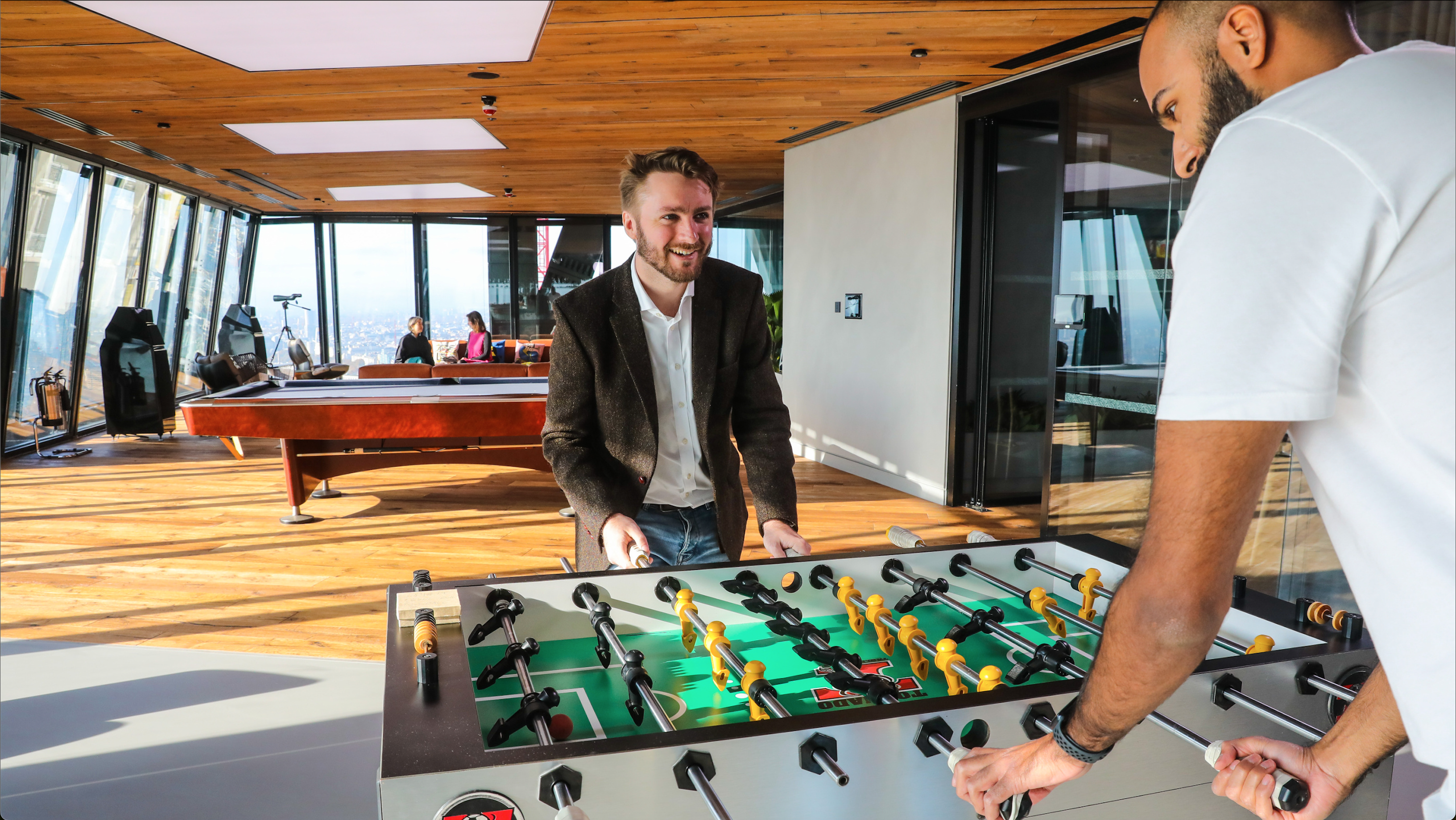 Group of employees having a meeting within the glass meeting room